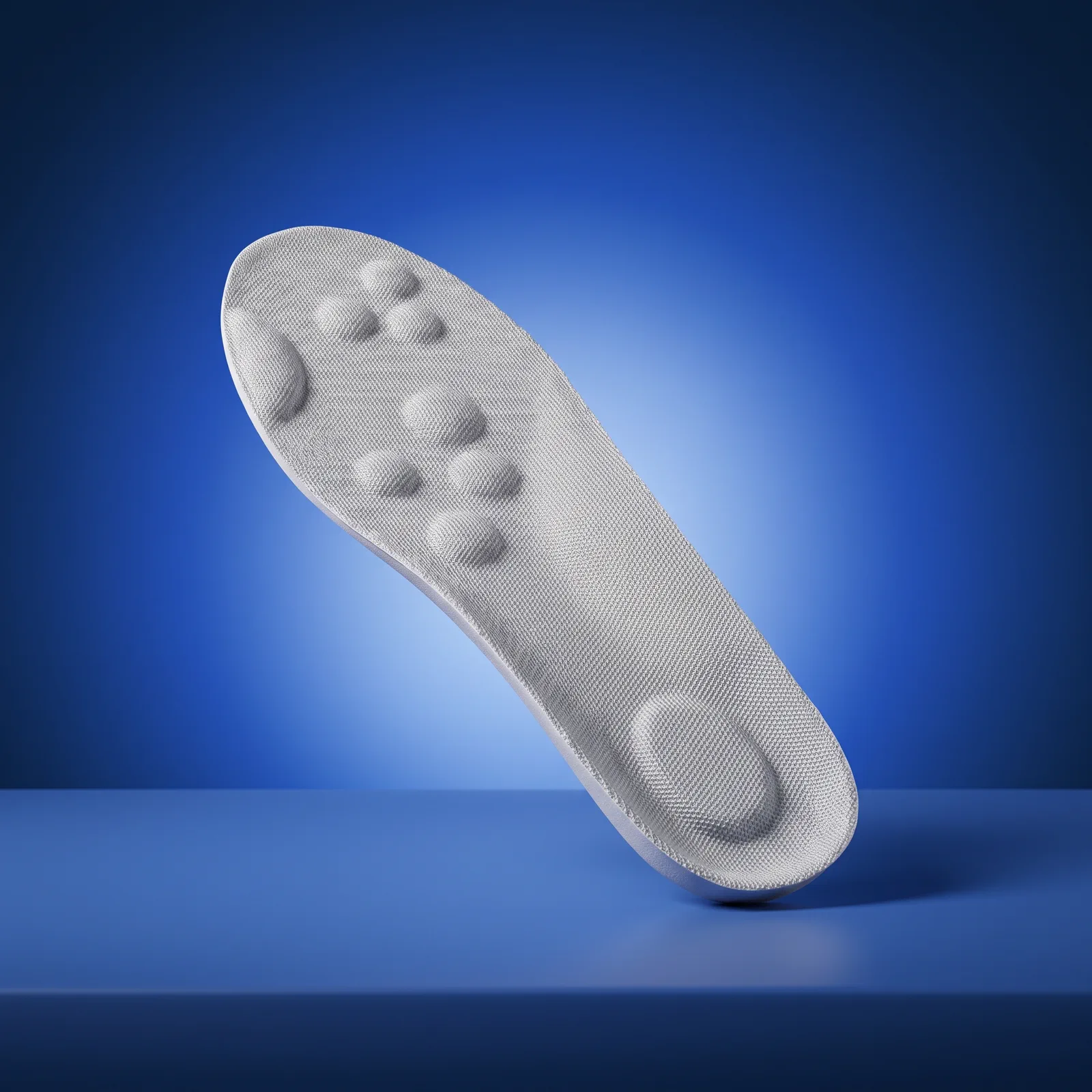 A Light Gray insole showing its contoured arch and cushioned heel